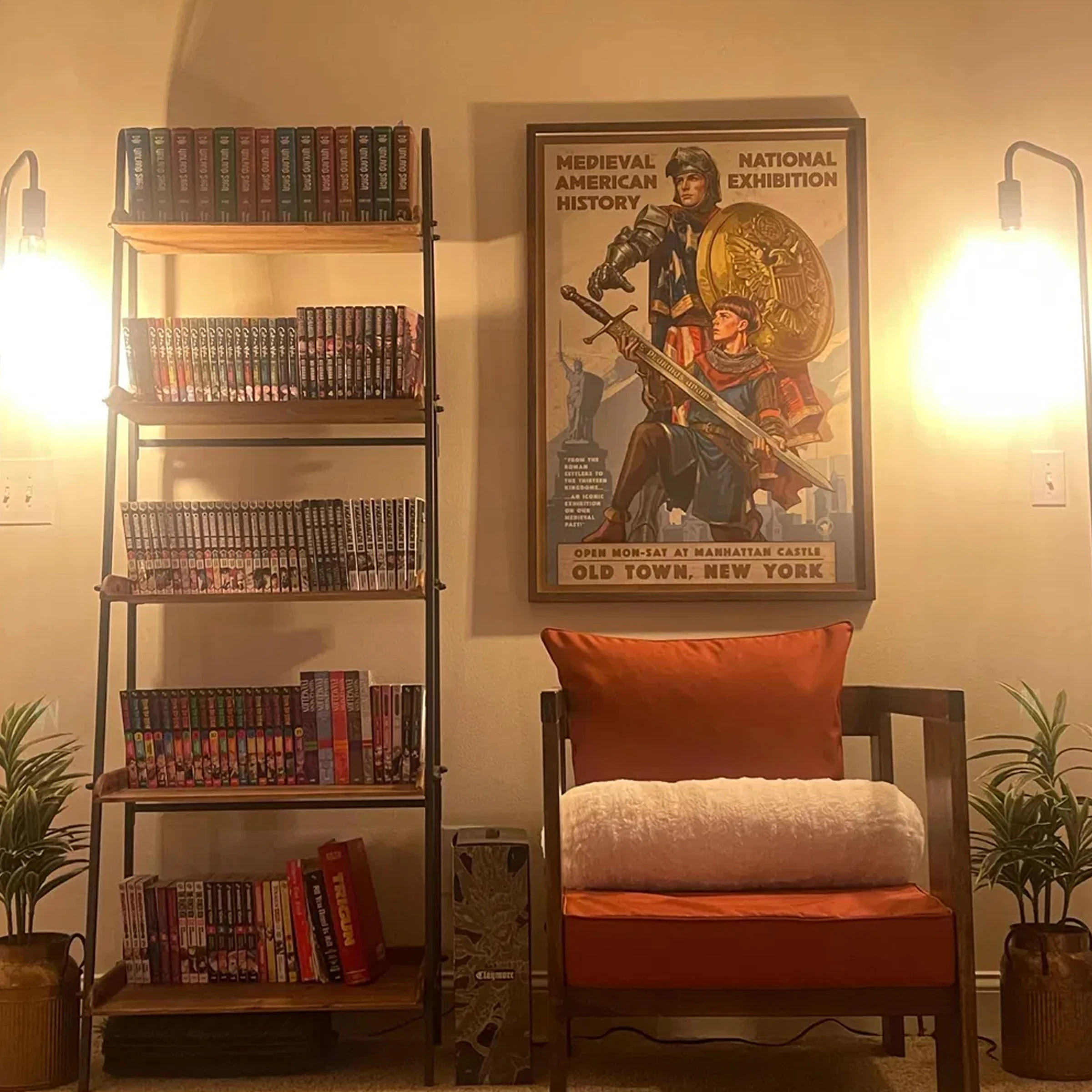 The framed American Kingdoms exhibition print displayed beside a bookcase and reading chair